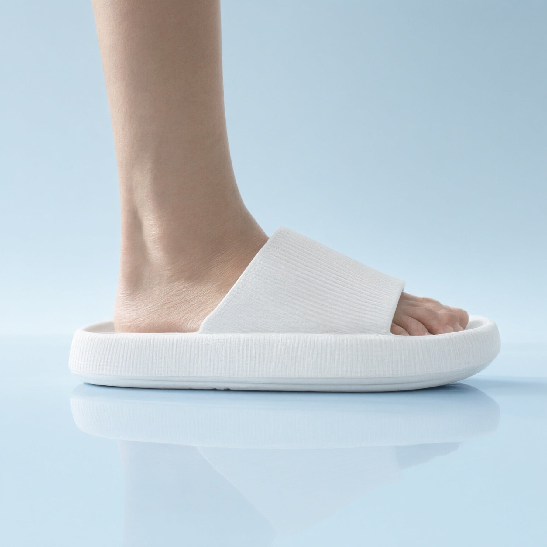 Side view of a White Puffy Slide showing its thick cushioned sole