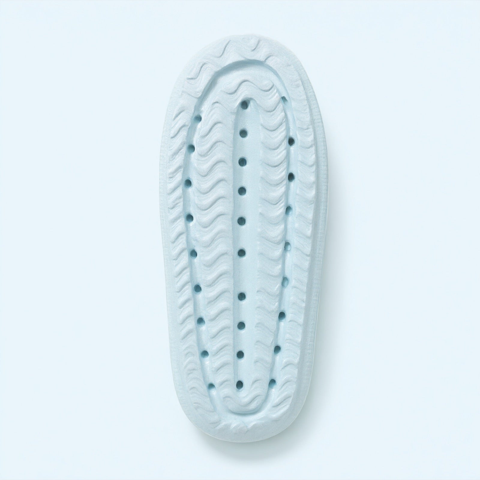 The underside of a Puffy Slide: wavy tread, drain holes and a rounded heel