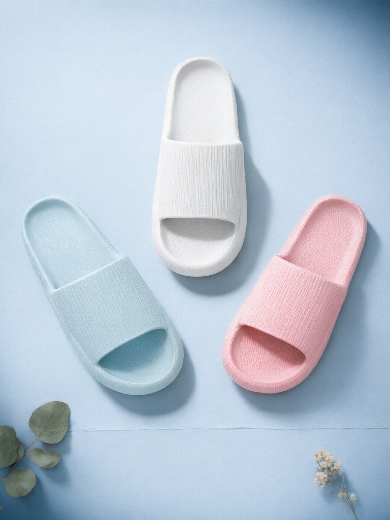 White, Baby Blue and Pink Puffy Slides laid out together