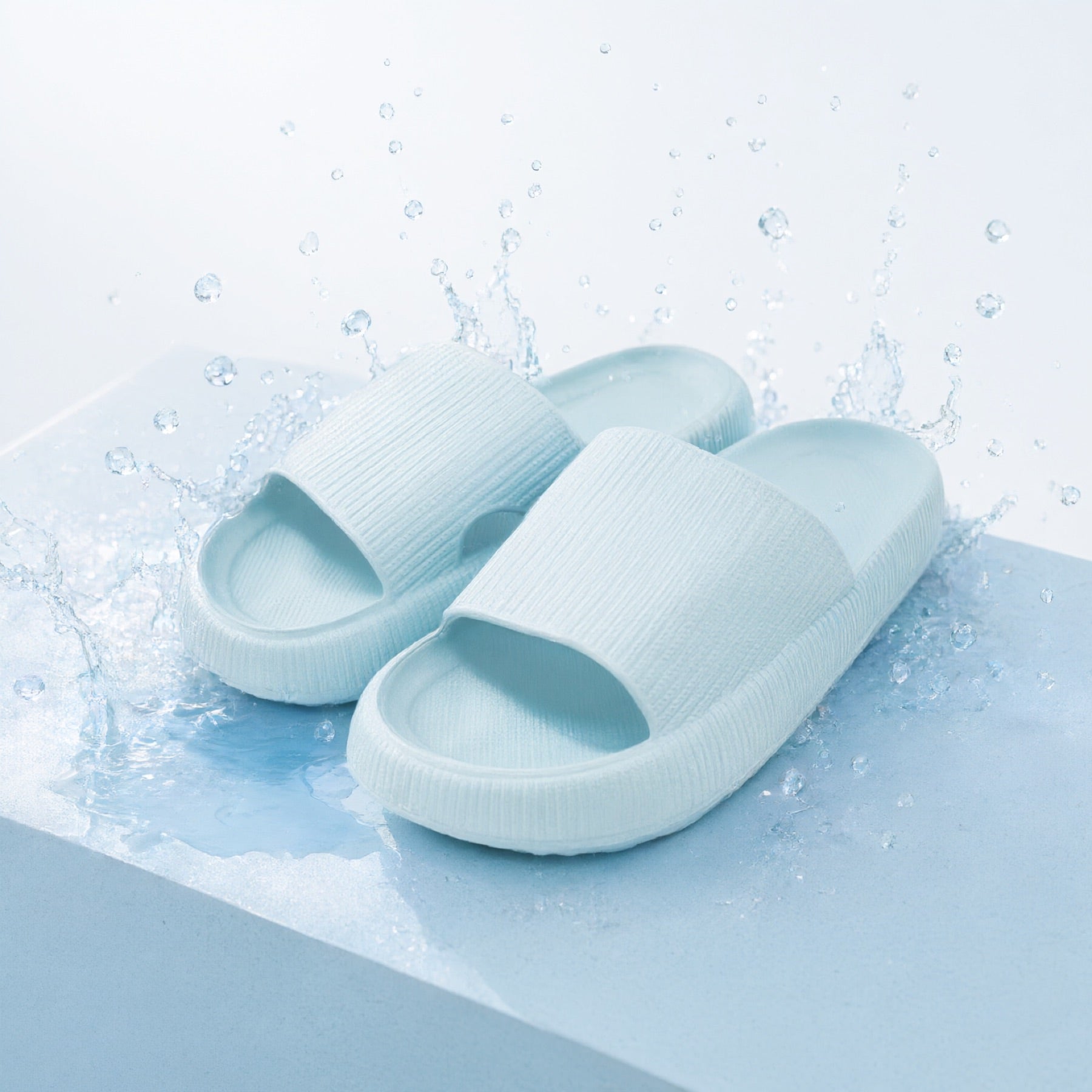 Baby Blue Puffy Slides splashed with water